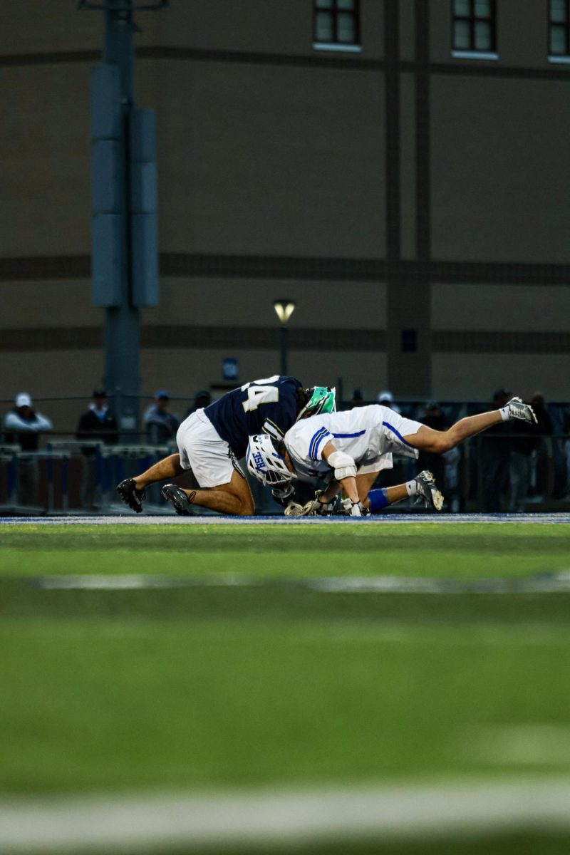 Junior Nick Weber Fights for the ball during a Faceoff