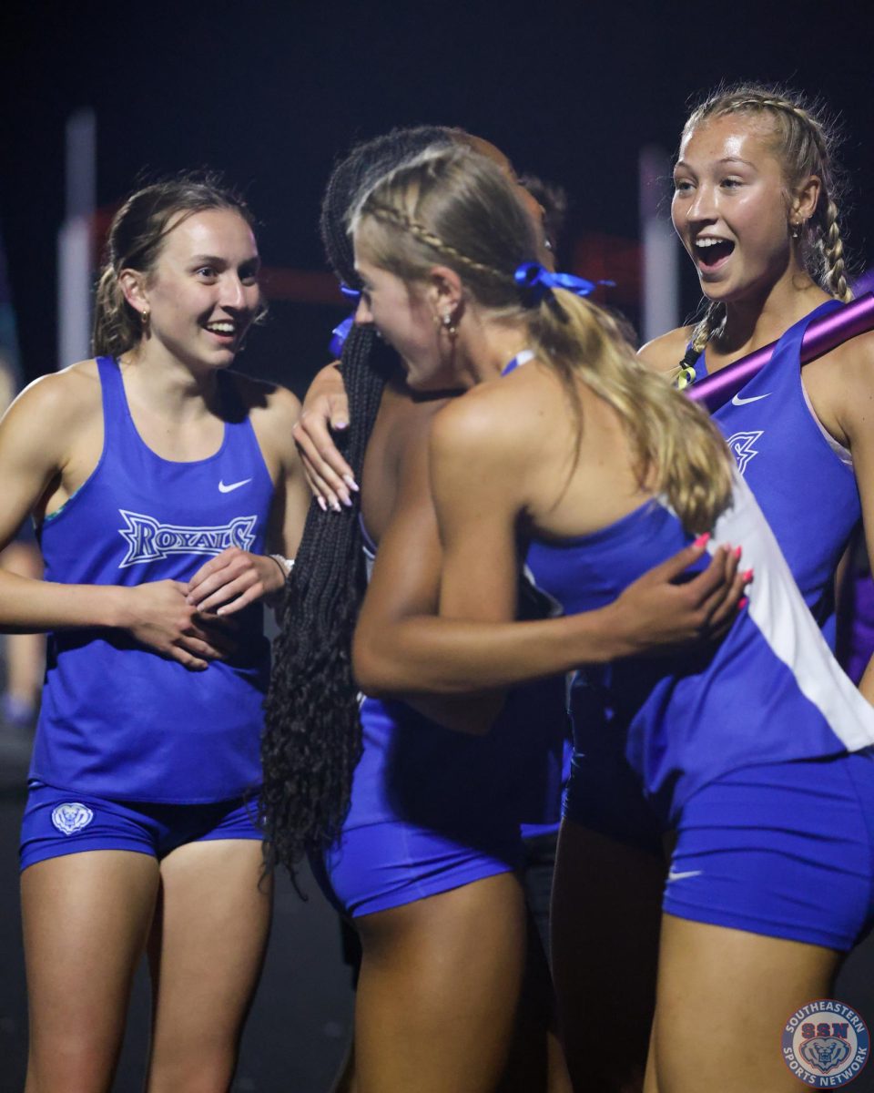 Chloe Senefeld and Anissa Lammie embrace while Elizabeth Butler and Ciara Kepner joyfully celebrate around them.