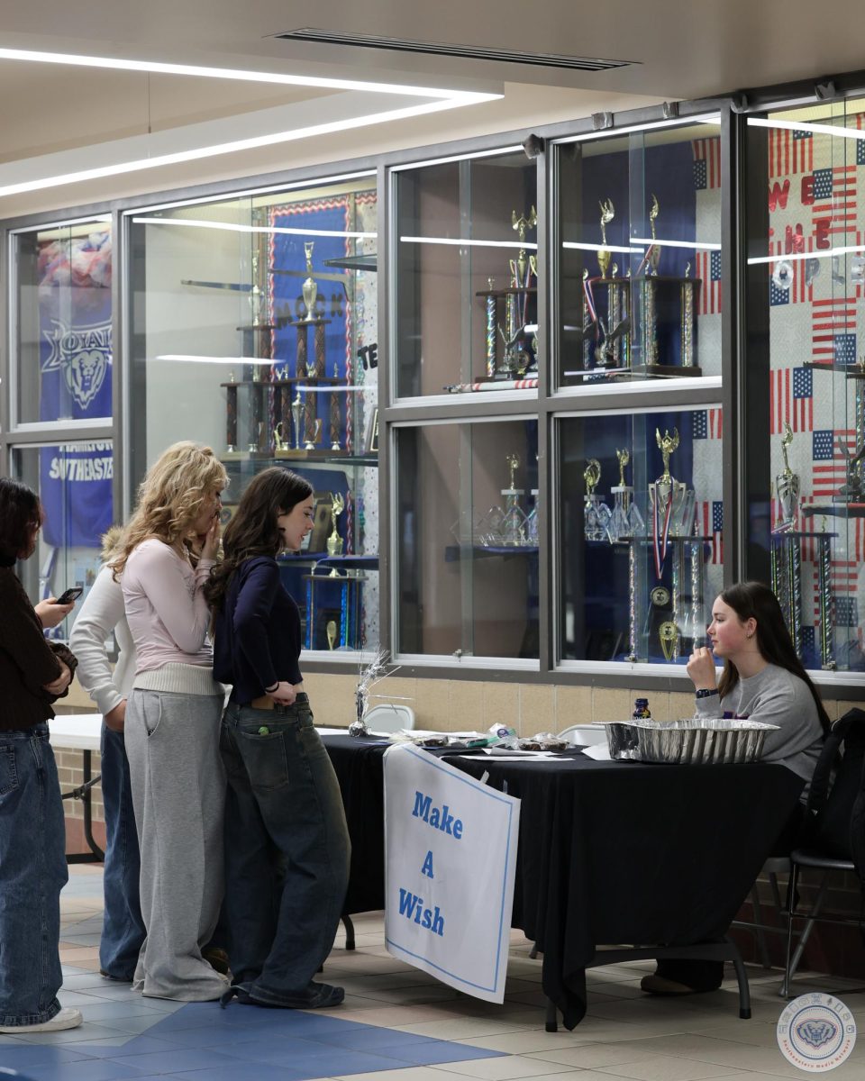 Lauren Van Hosen runs HSE Make-A-Wish Bake Sale booth outside of main cafe on Mar. 13, 2026.